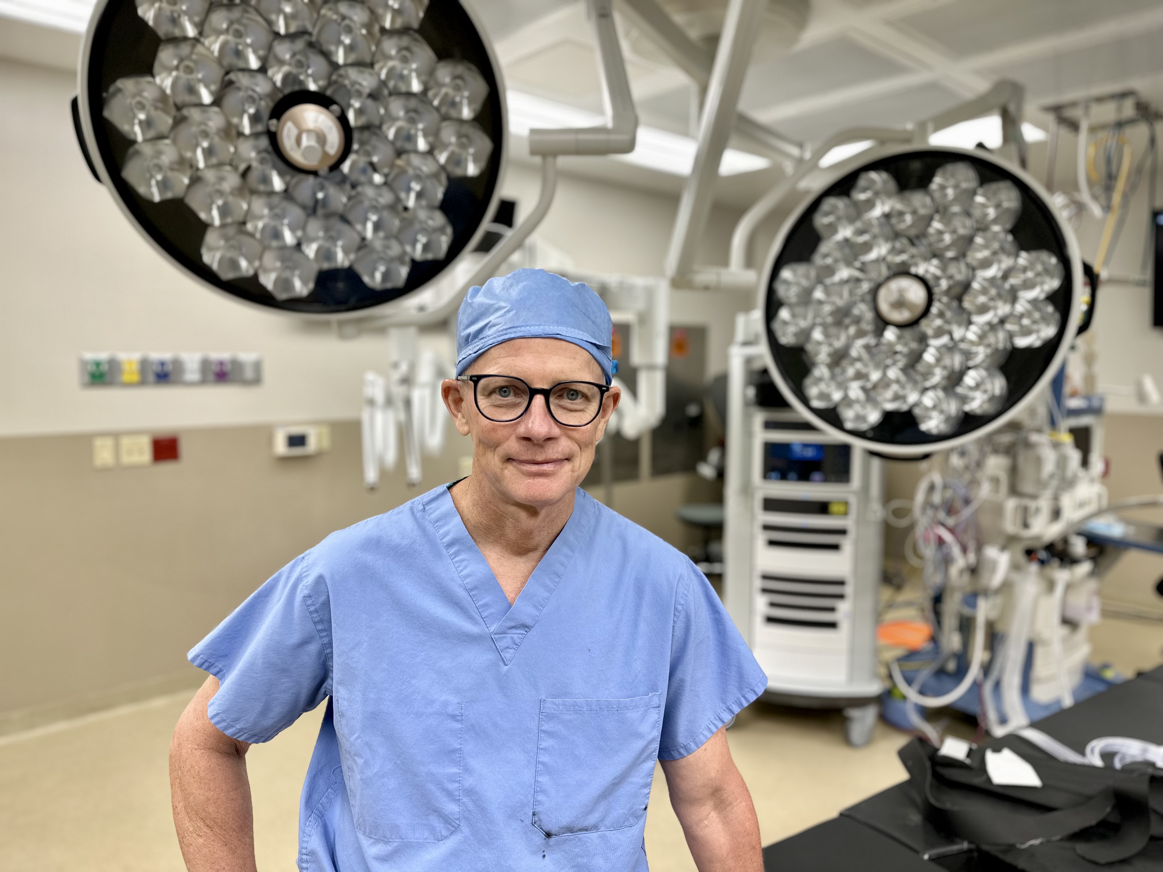 Dr. Torr Carmain posing for picture in operating room.