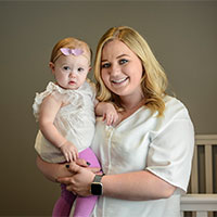 Brindee smiles while hugging her daughter.