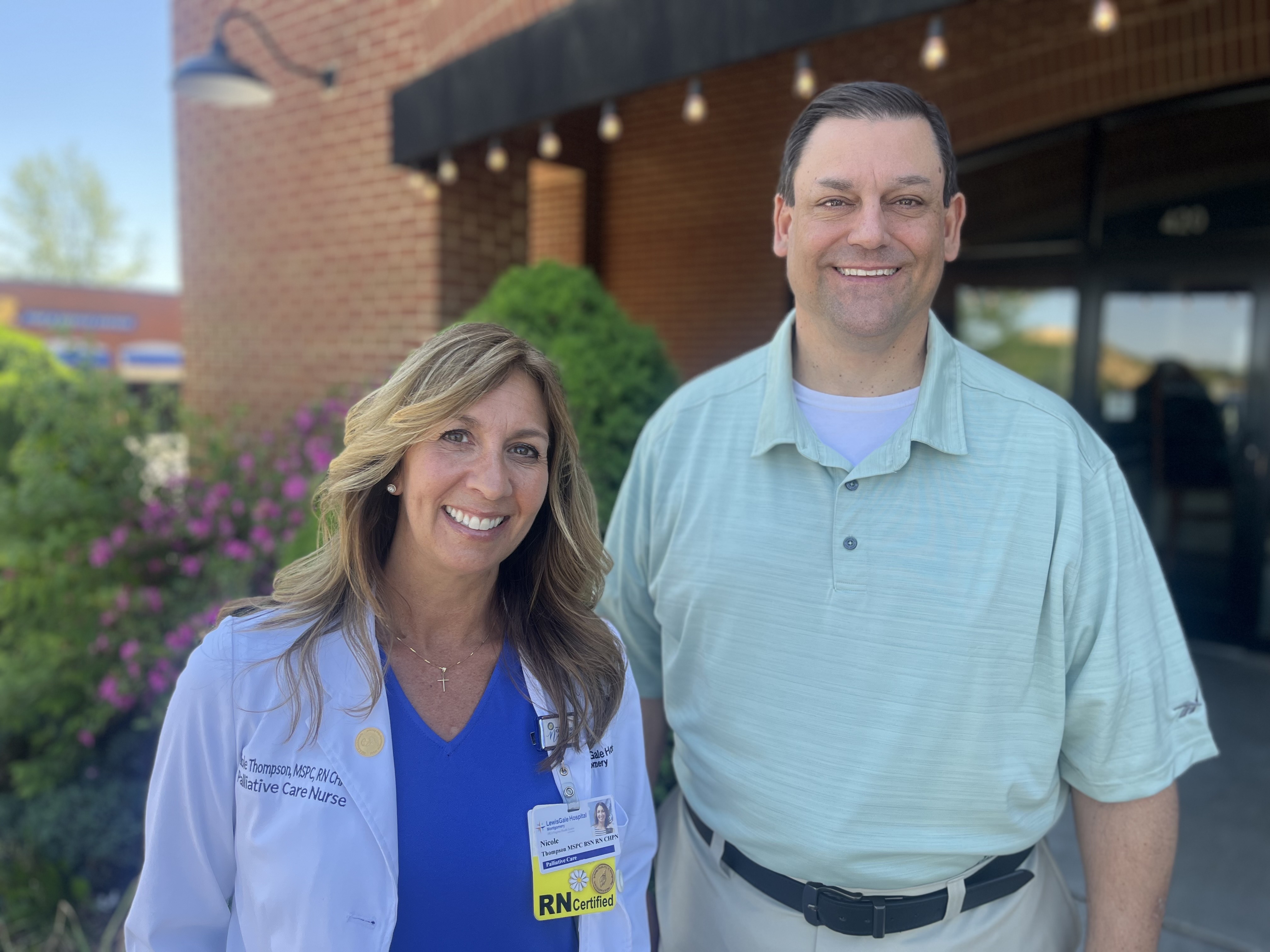 Nicole Thompson stands in between her supervisors. On her left in the photo is Beth Scott and to her right is Chief Nursing Officer Devin LaPuasa. The women are all smiling and looking forward. They are standing inside a restaurant.
