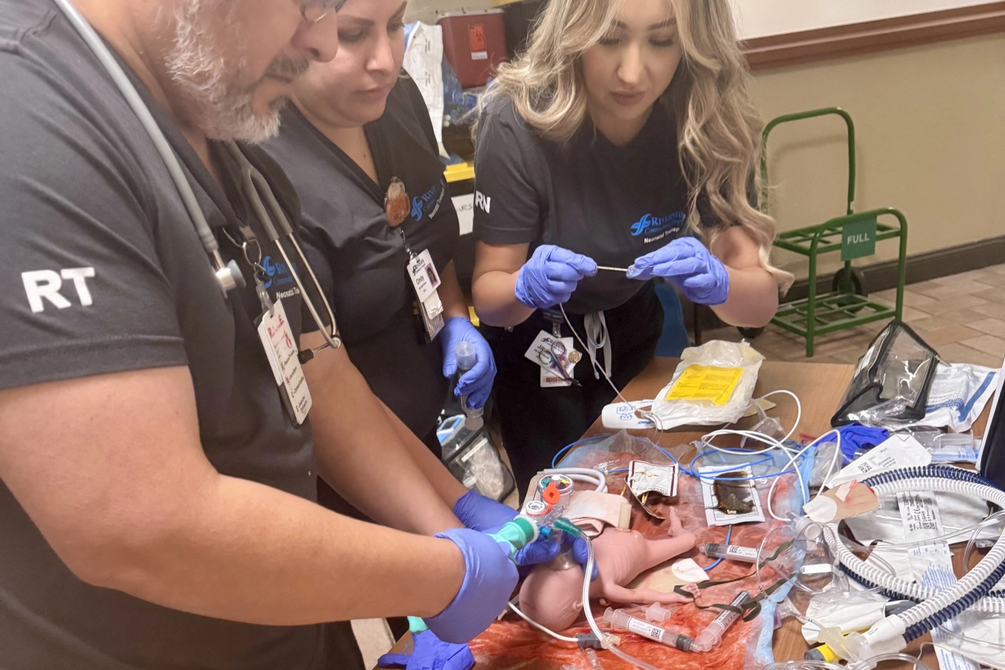 NICU nurses and Respiratory Therapists doing hands-on simulation learning.