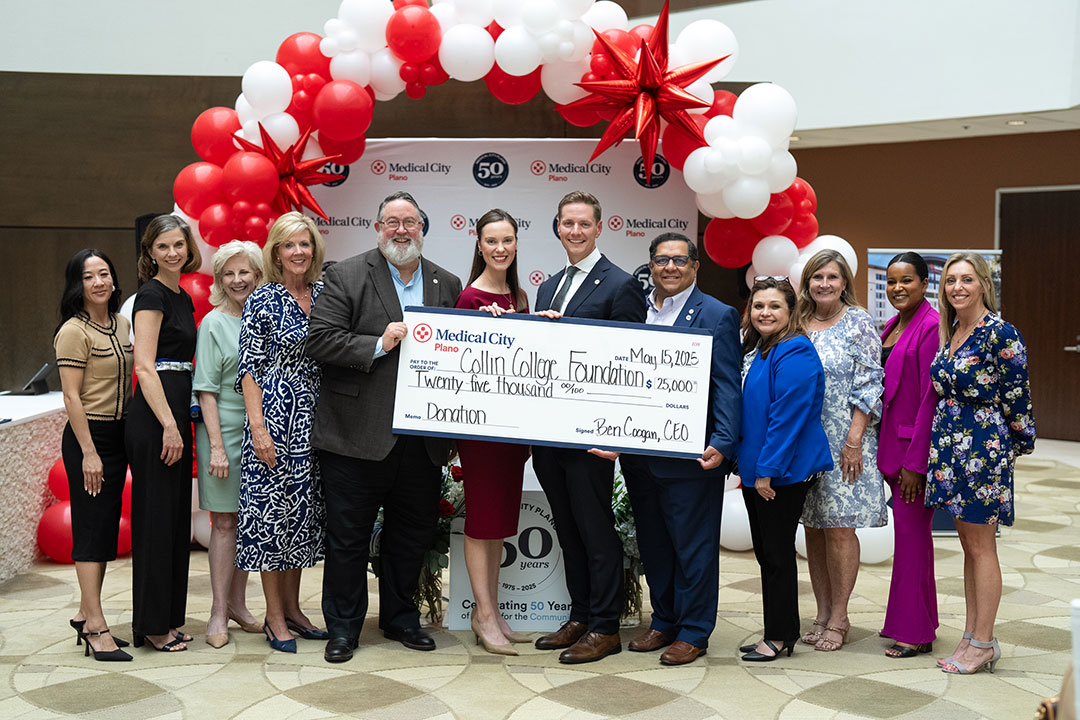 Leaders from Medical City Healthcare and Medical City Plano present a $25,000 donation to the Collin College Foundation in front of red and white balloons
