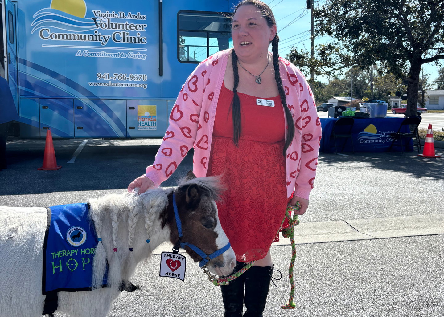 Hope, the miniature therapy horse from Branded Heart Stables visits Sarah Lehmen, a Leadership Englewood class member.