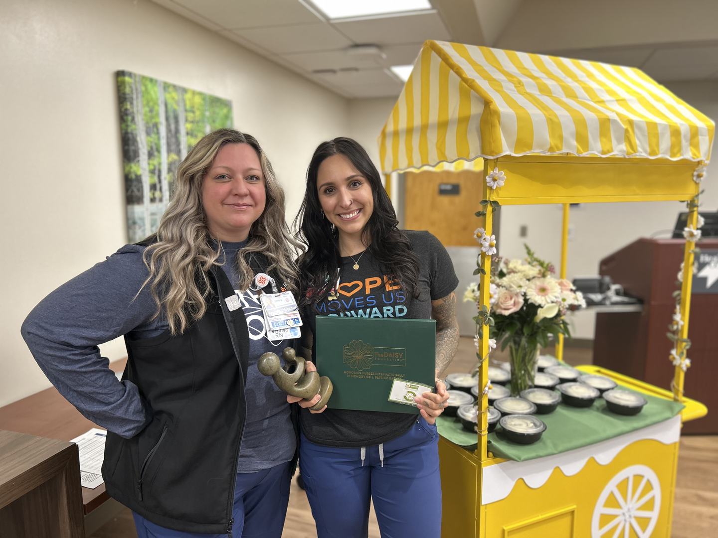 Daisy Nurse Leader Shanaya Sharpe and Erin Glisczinski standing, holding the award.