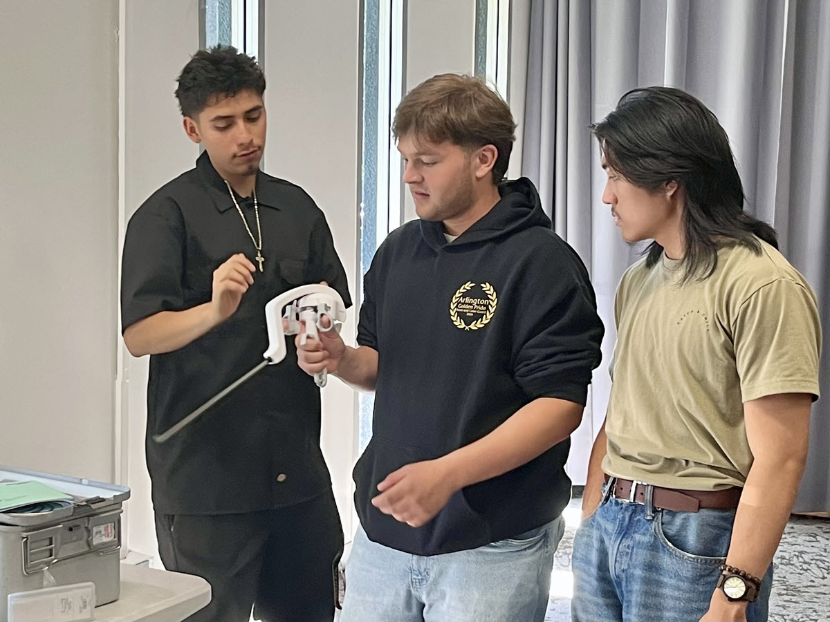 Students learning with robot arms.