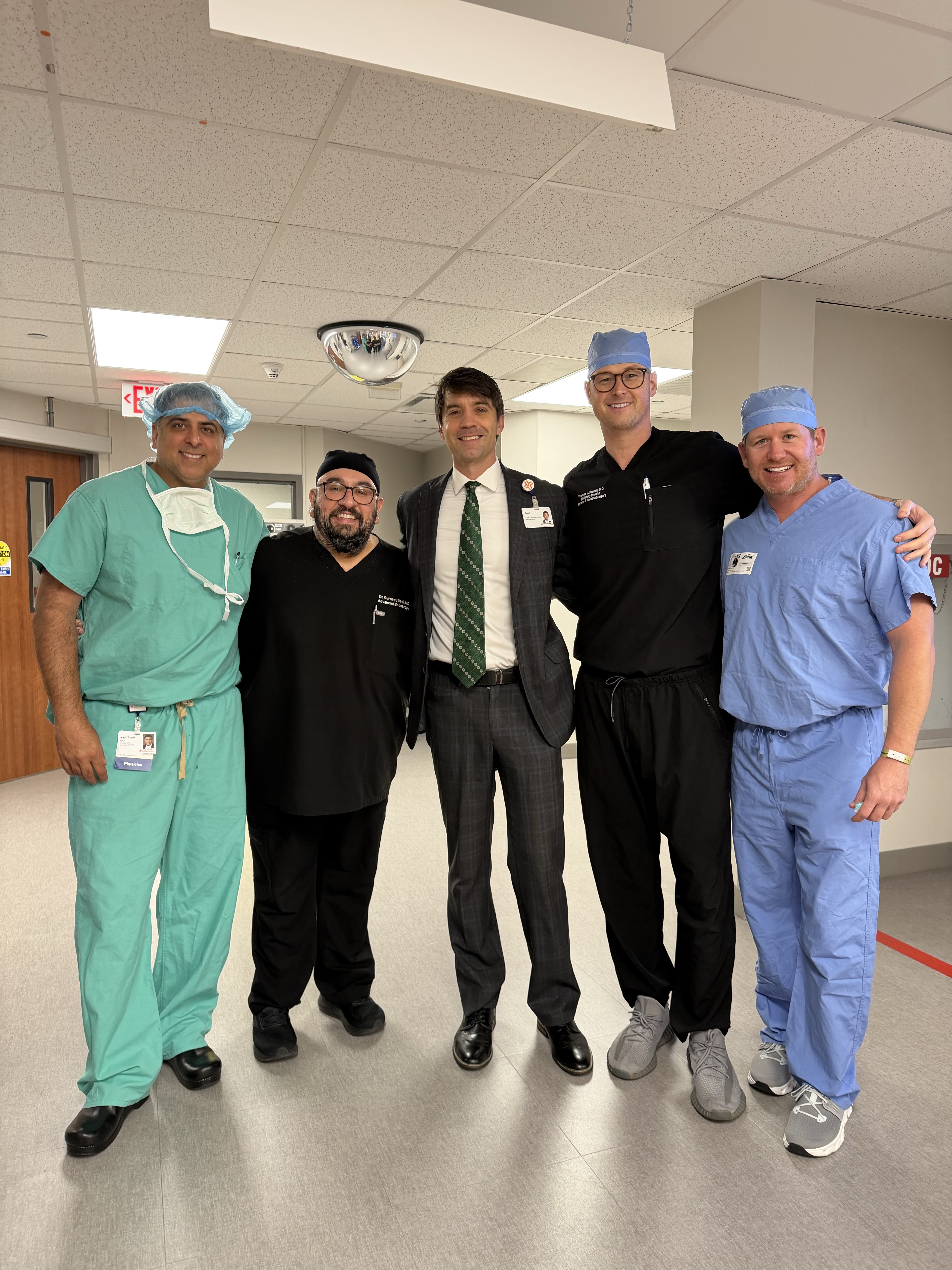 TIF procedure team of 5 standing in hospital hallway