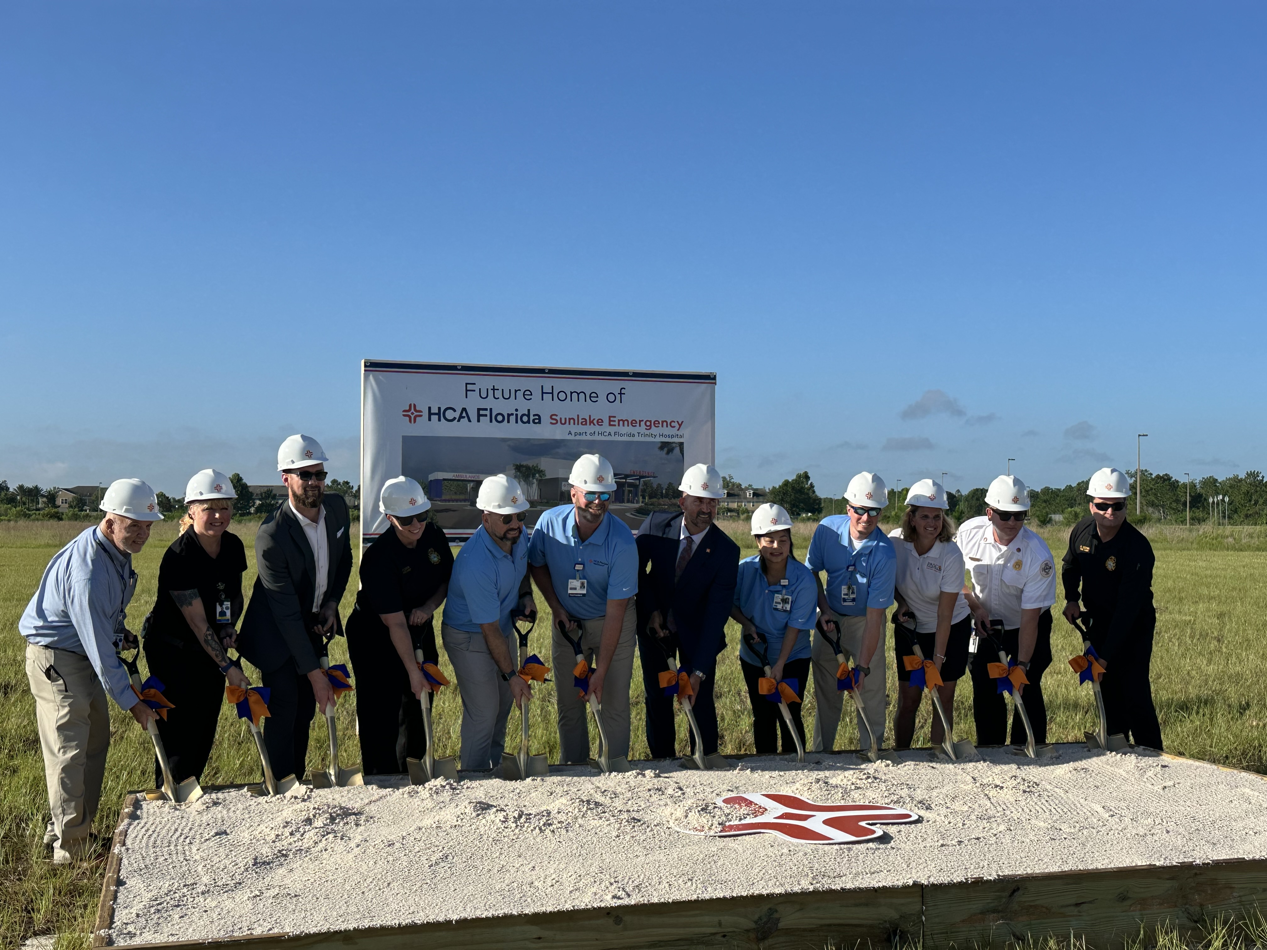 Trinity Hospital team with shovels breaking ground on Sunlake Emergency