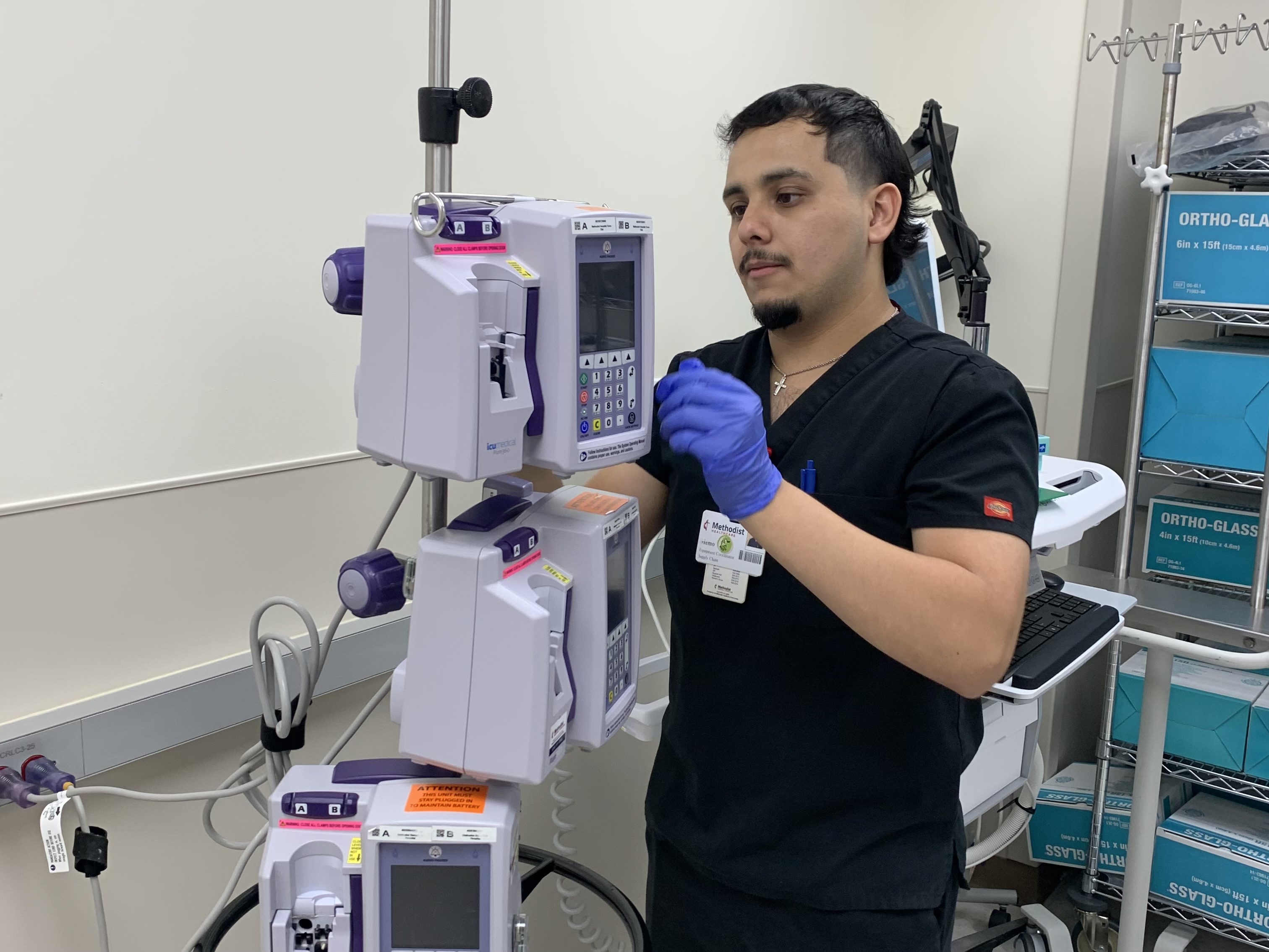 Memo Alaniz, equipment coordinator inspects medical equipment before use.