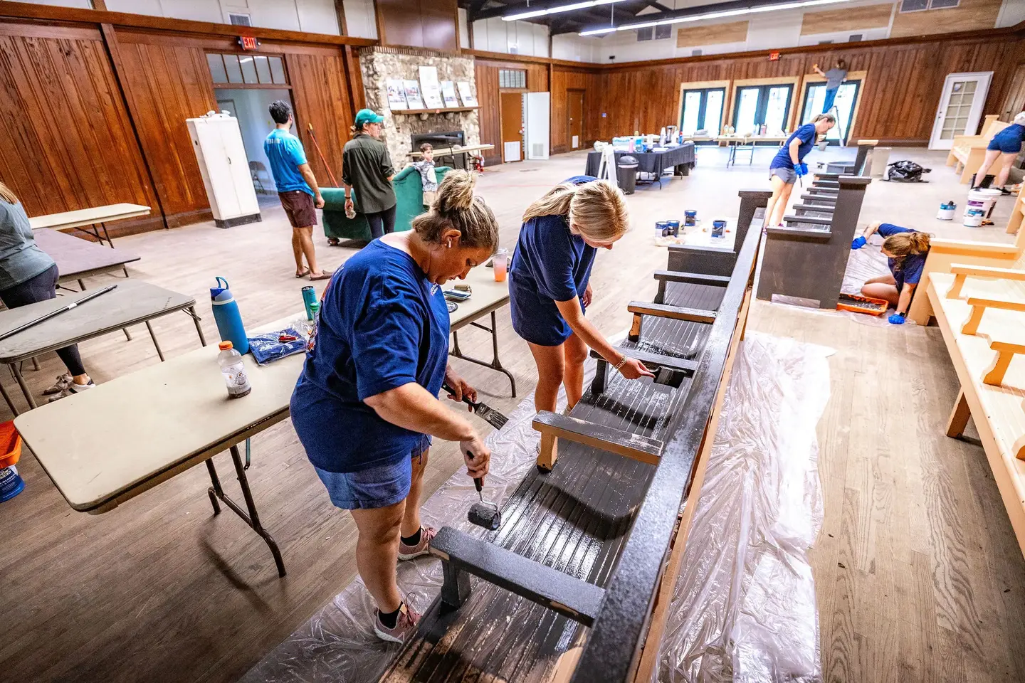 Volunteers painting benches.