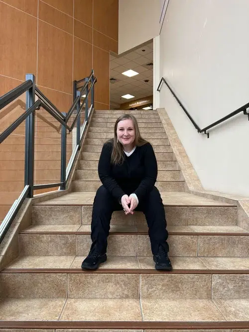 Esther Frantz sitting on stairs.