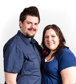 Aimee and Tyson smile while hugging.