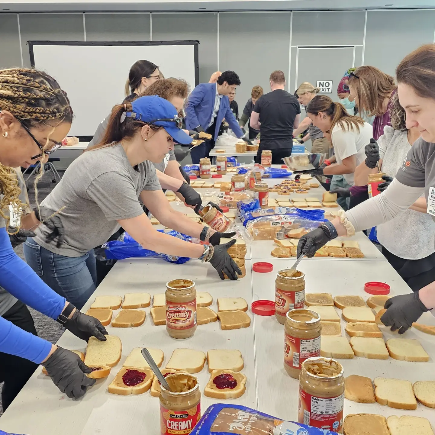 Menorah Medical Center colleagues making PB and J sandwiches.