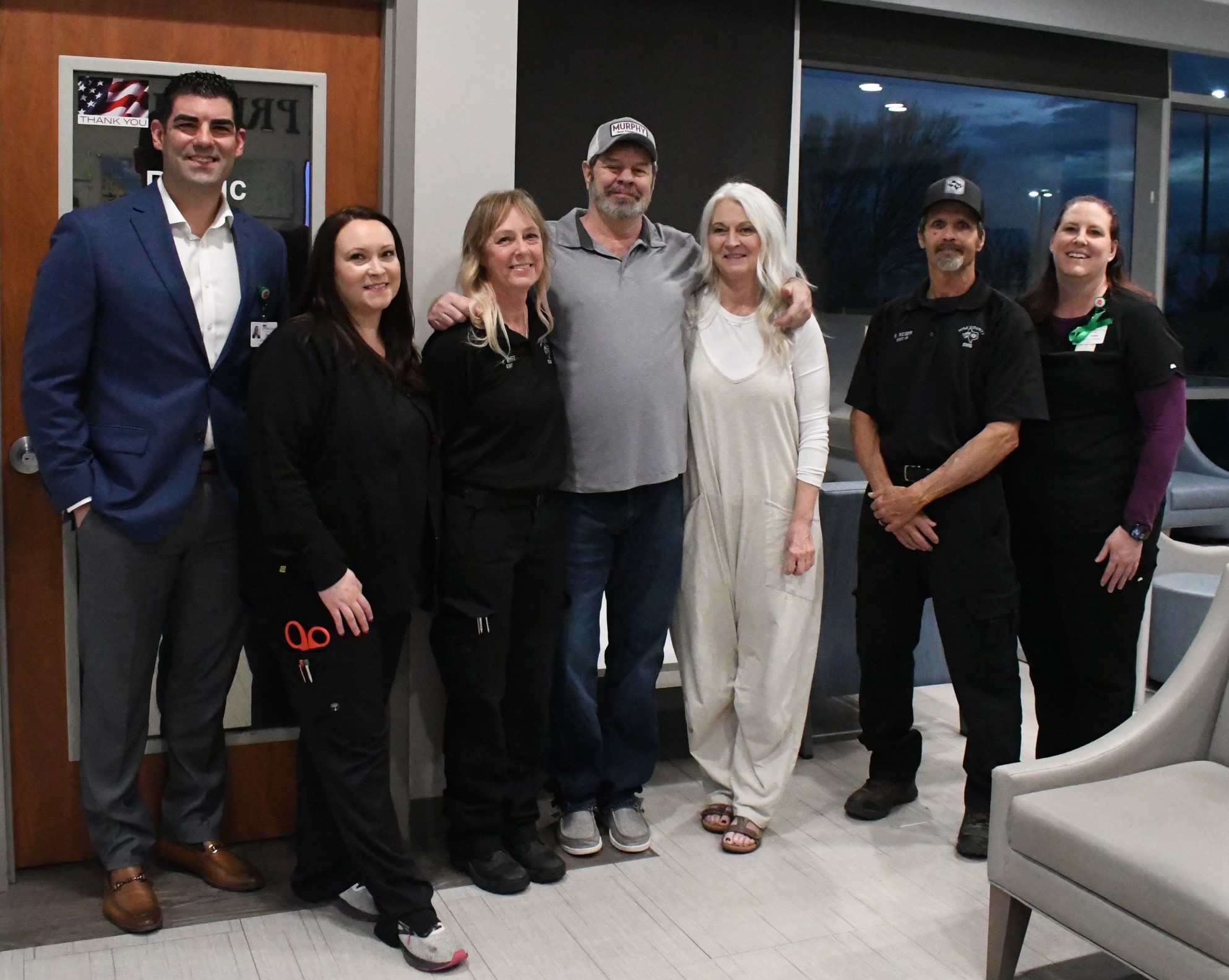 Steve Glenn standing with family and friends.