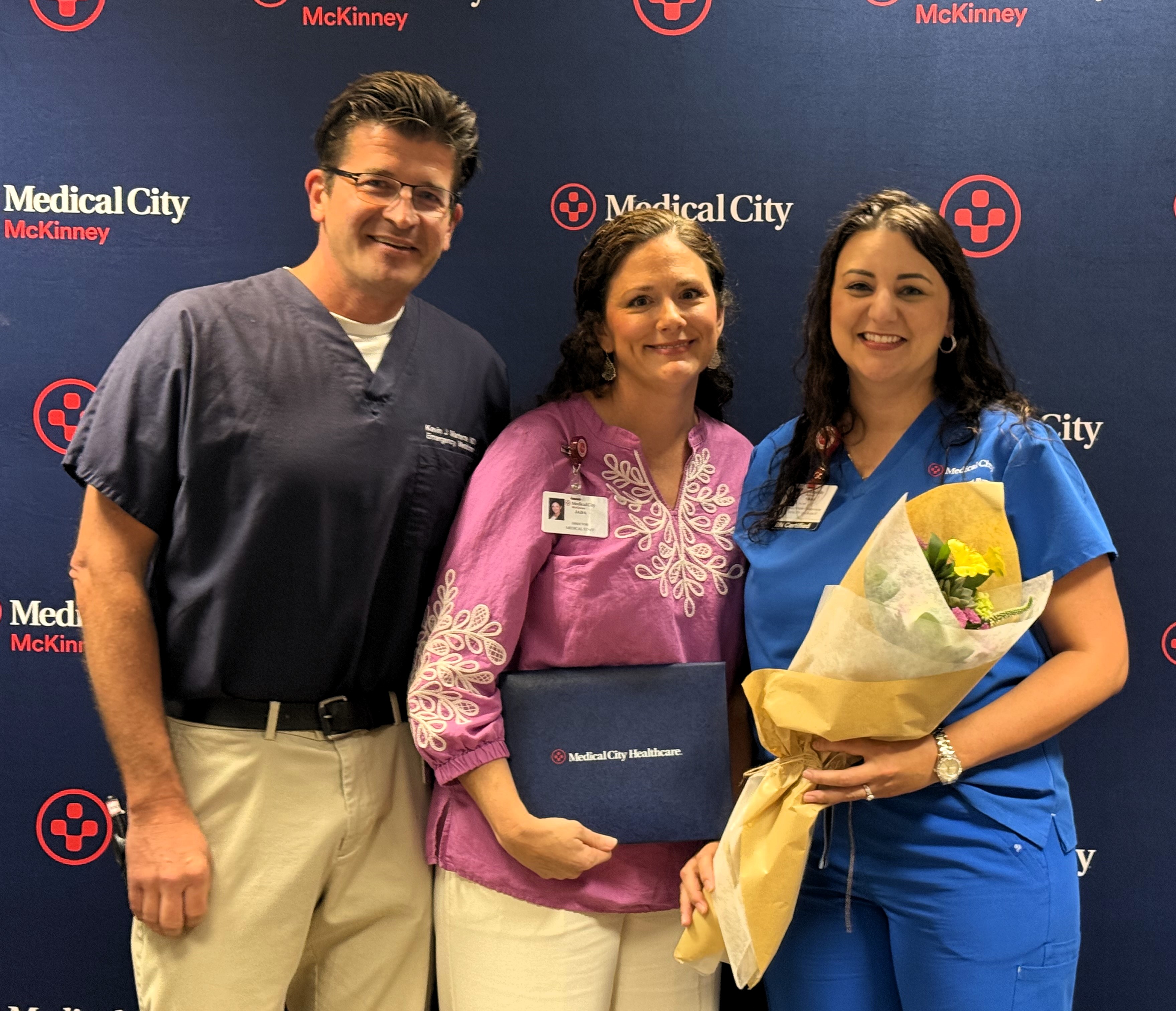 Dr.Kevin Martens Jada McClure and Nikki Dorzinski during the ceremony