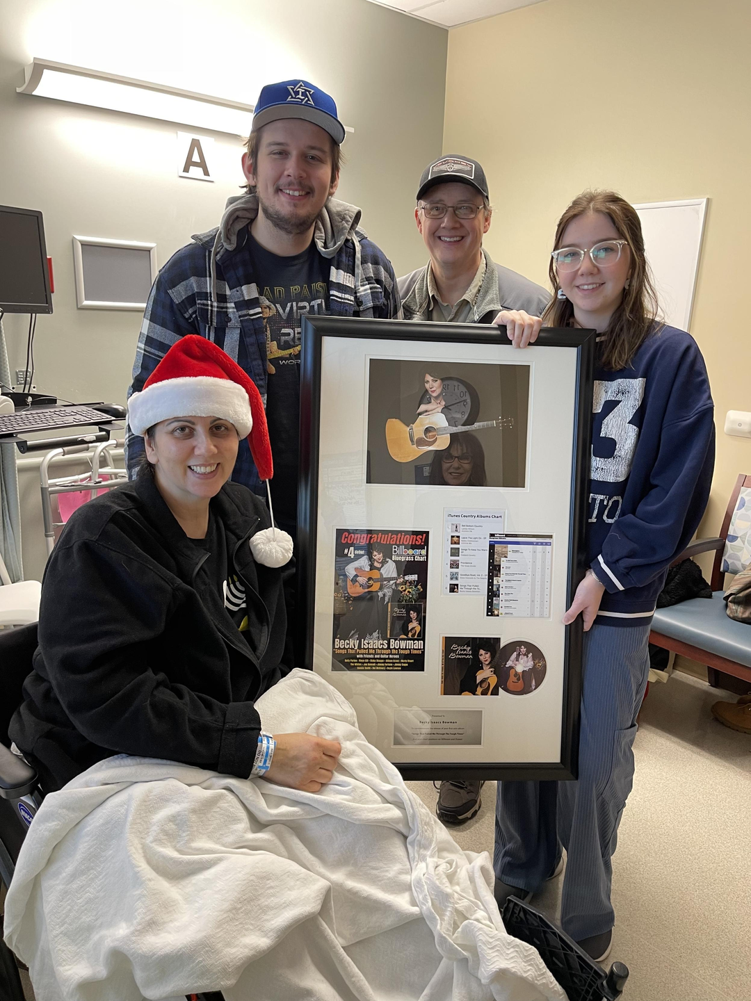 Becky with her family holding her chart topping album that was nominated for a Grammy.