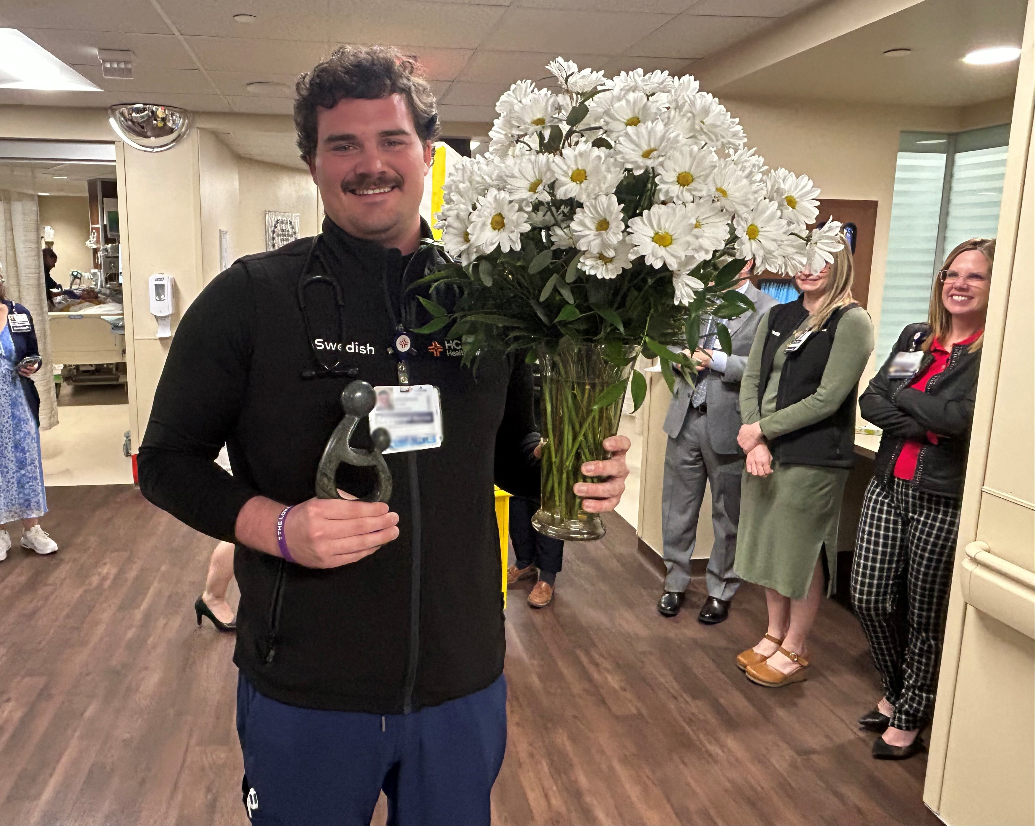Brooks Owen poses with the daisy award.