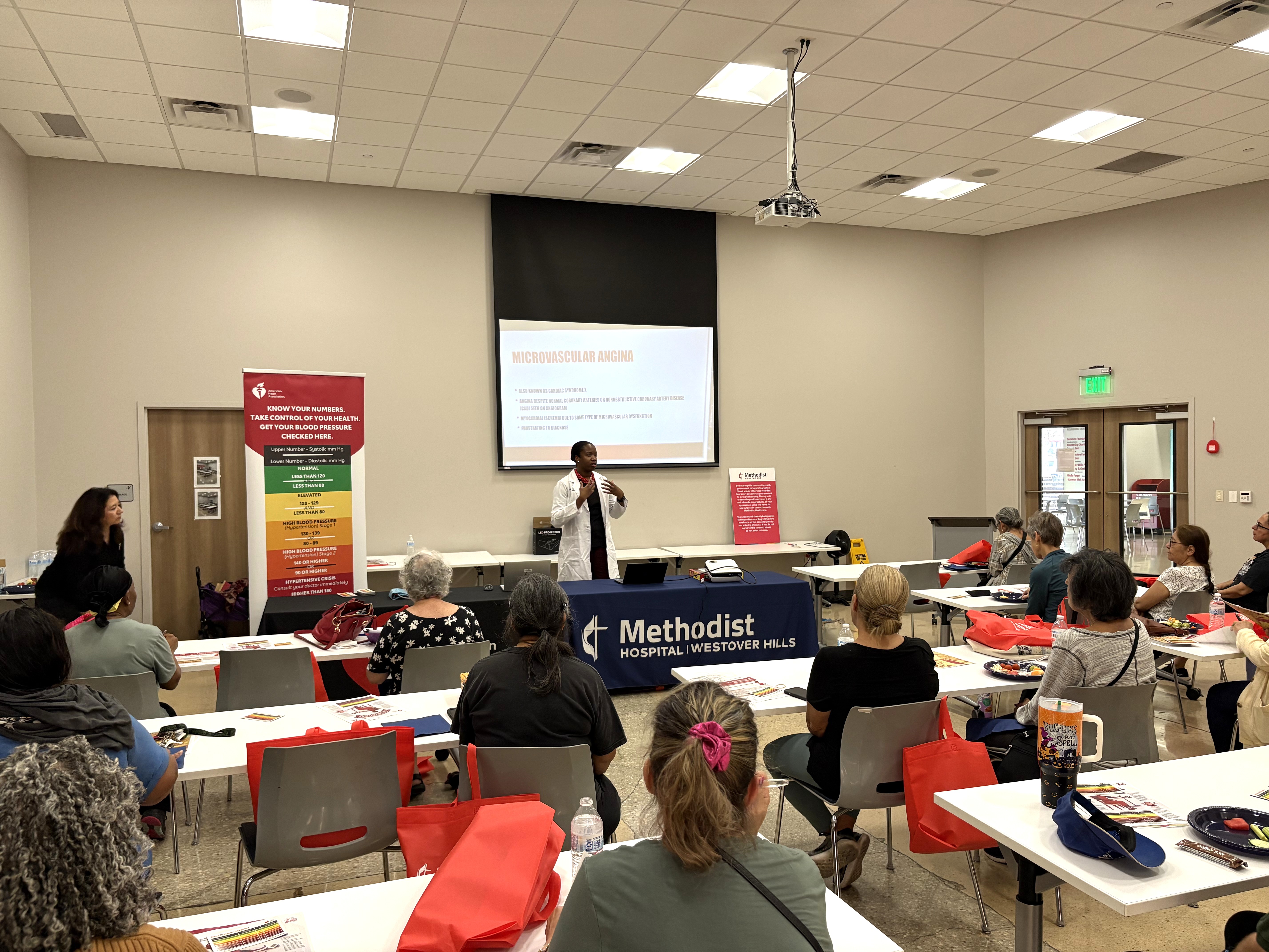 Doctor presenting information on cardiovascular health to a room full of YMCA members.