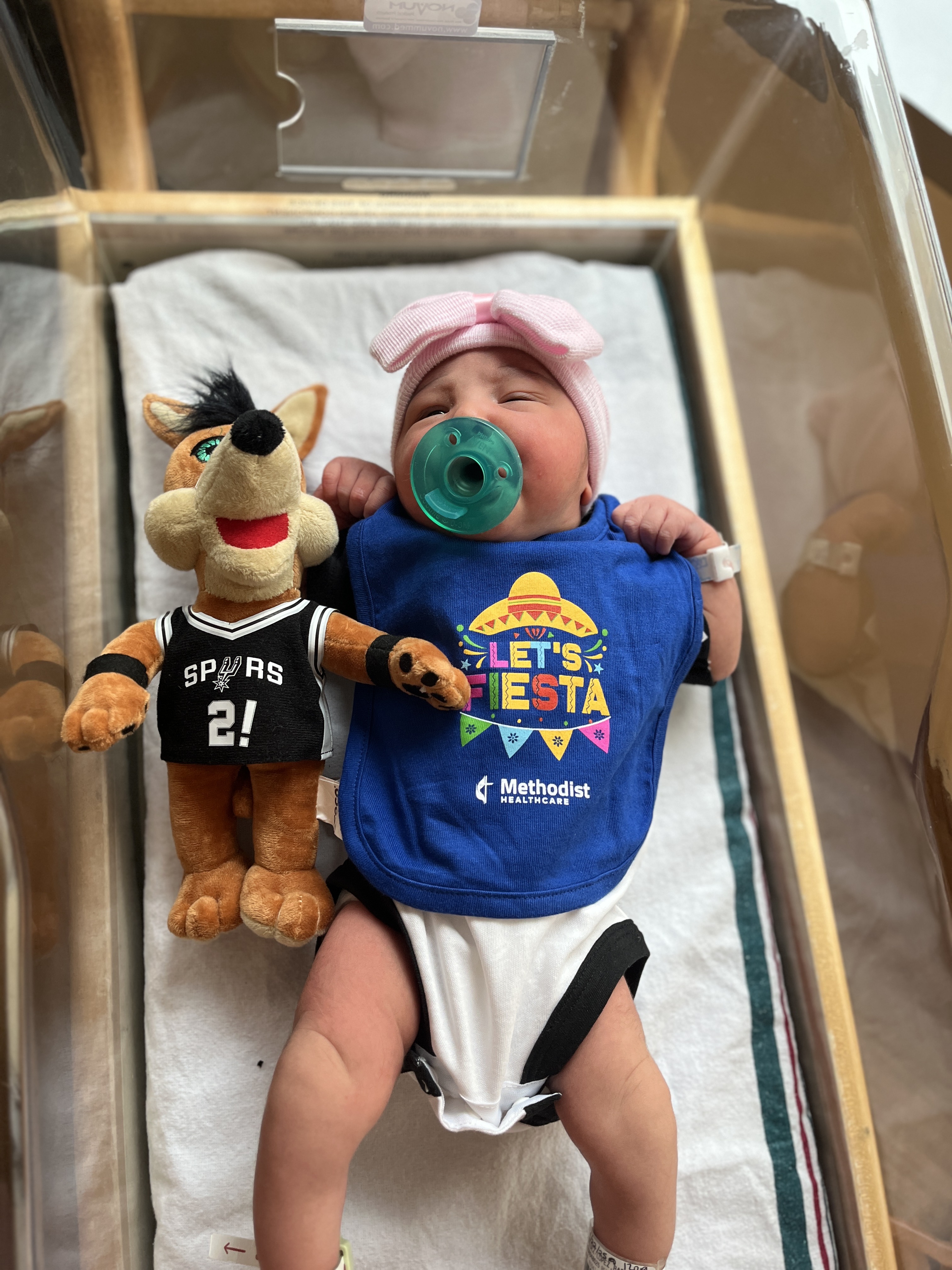 Baby celebrate their first Fiesta in custom bibs.