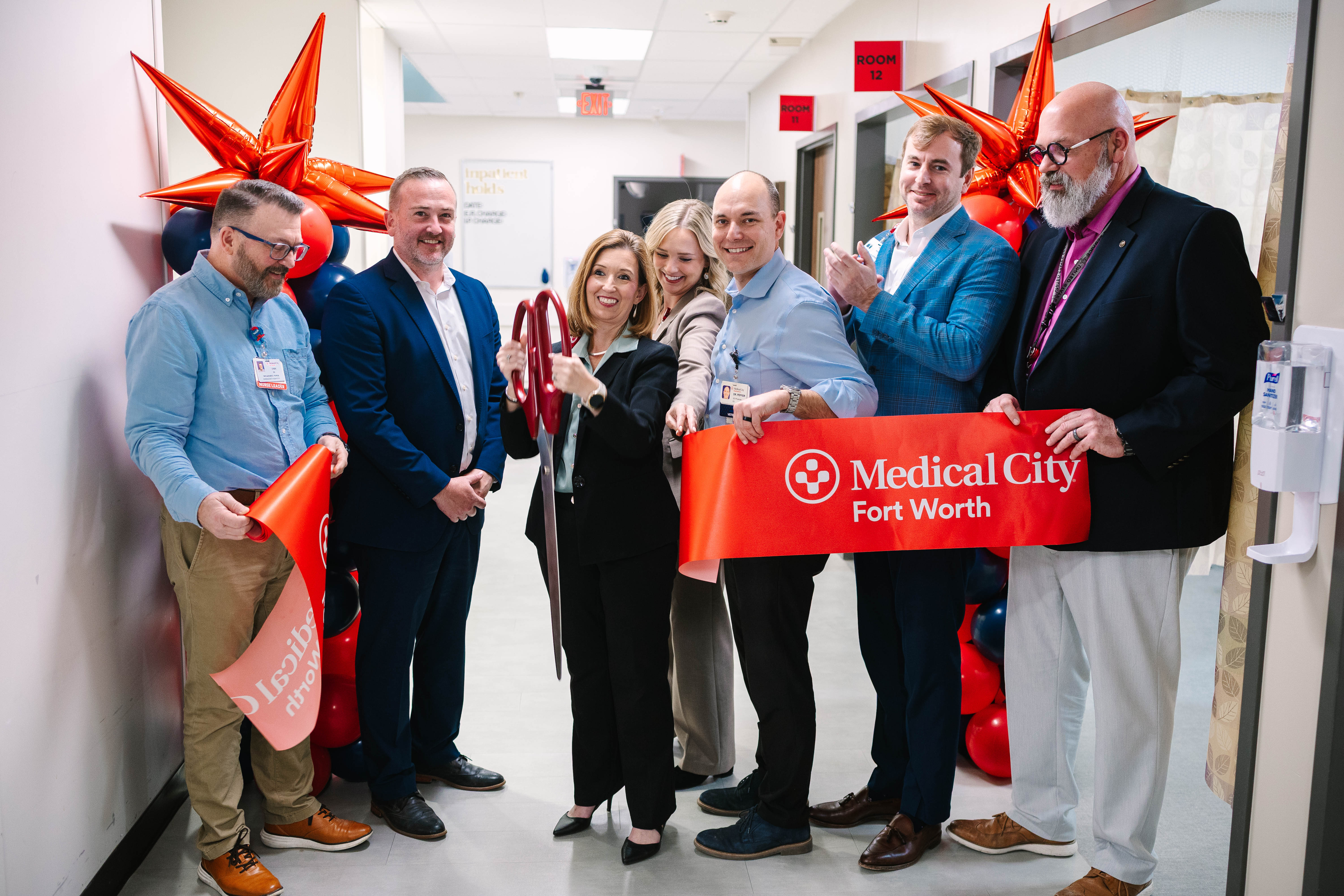 Hospital and ER leadership cheering during the ceremonial ribbon-cutting for the Medical City Fort Worth ER expansion.