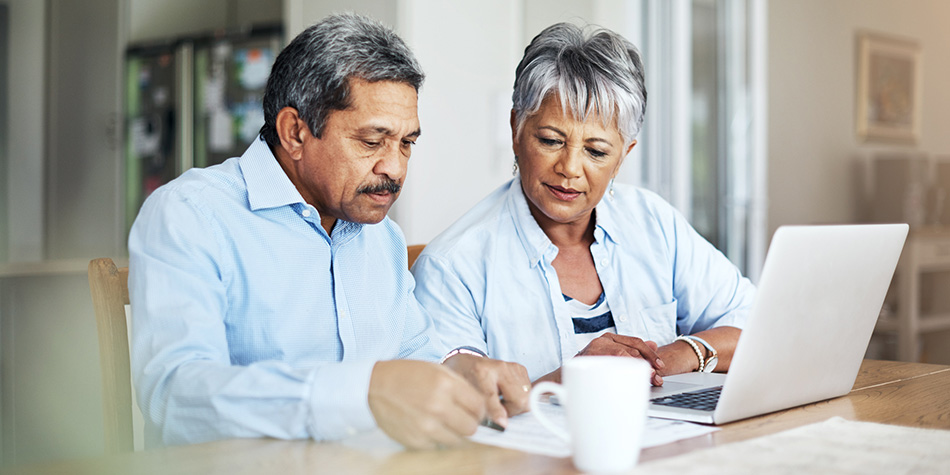 Man and woman sitting at a computer.