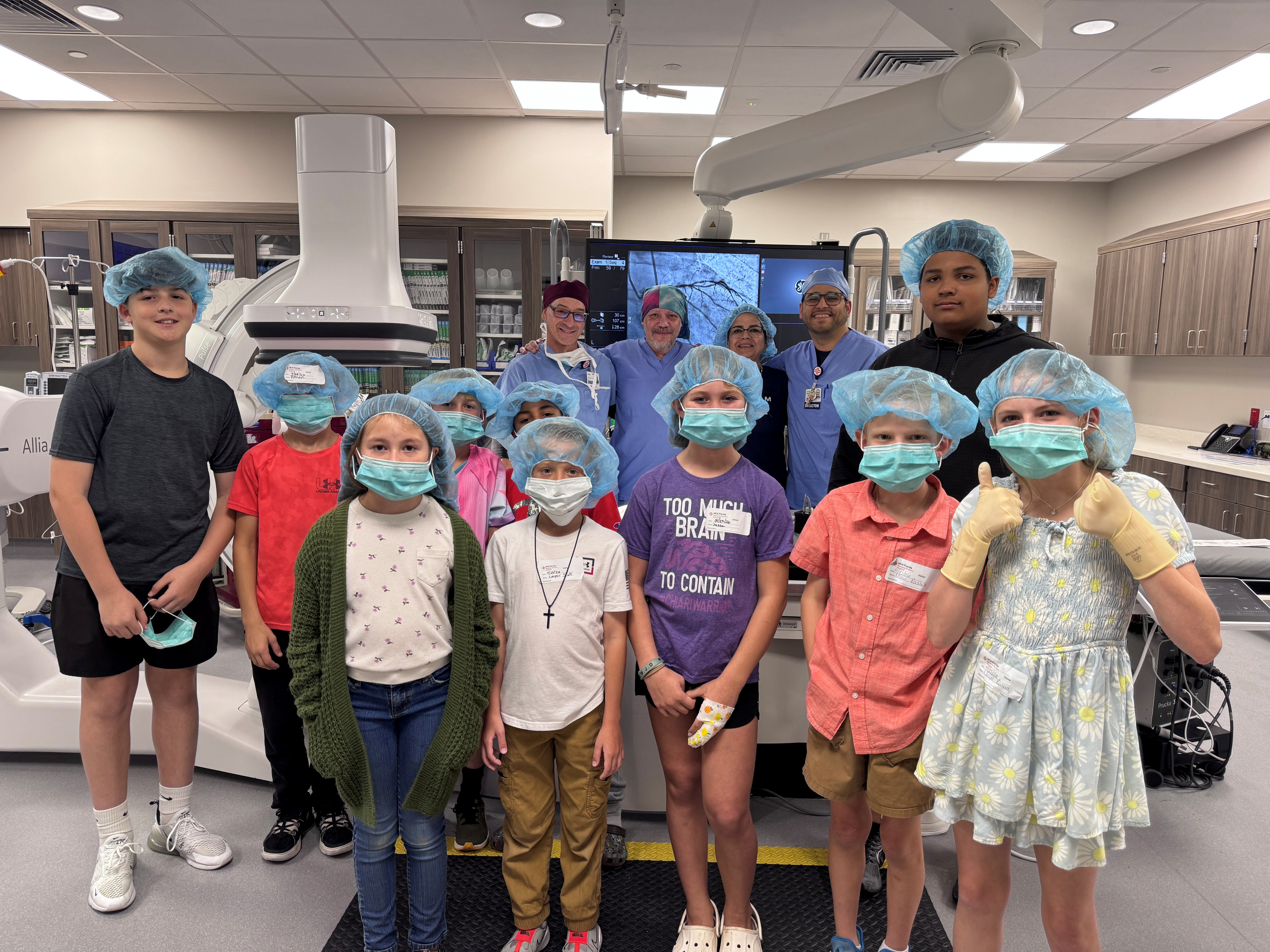 Children pose smiling wearing clinical outfits.