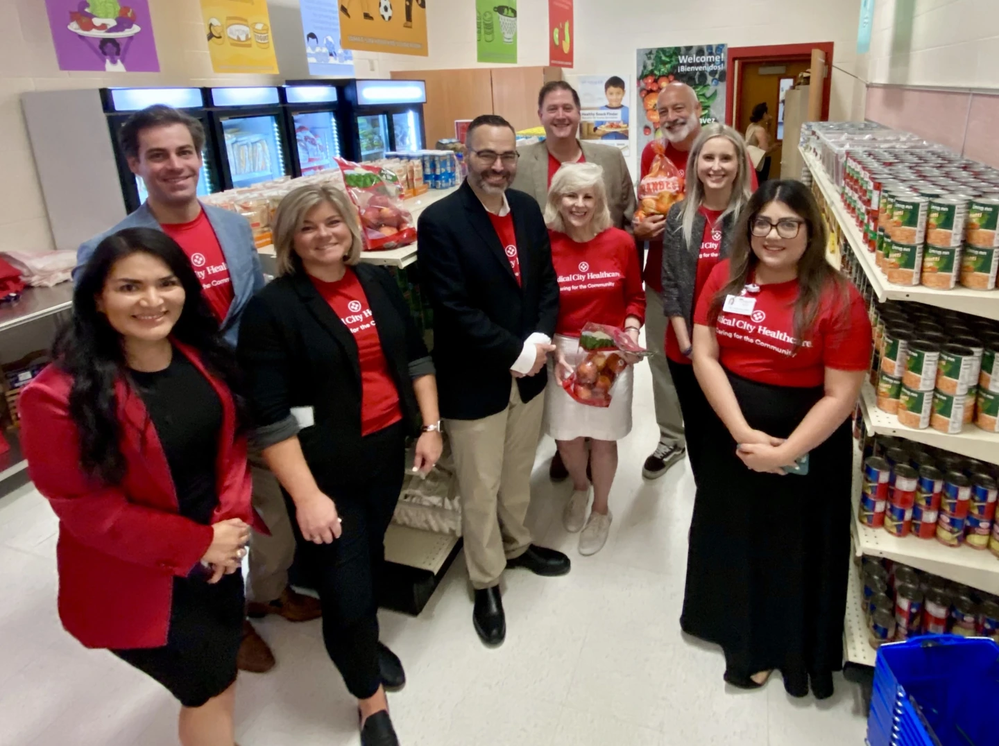 group photo inside food pantry with stocked shelves