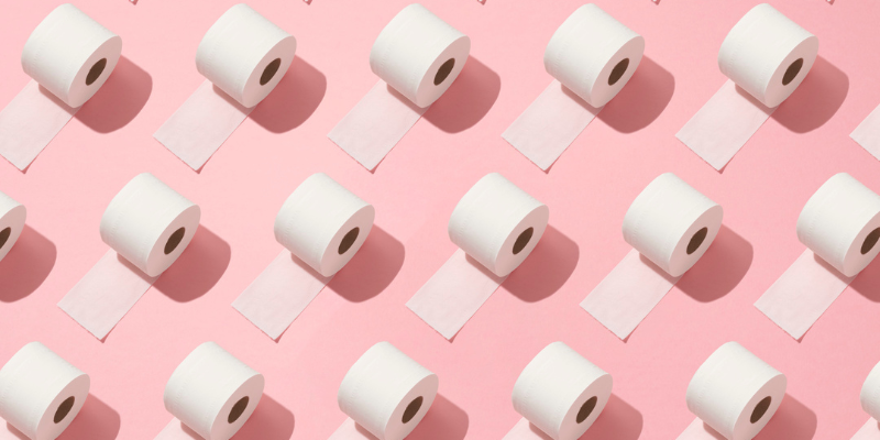 Rolls of toilet paper on a pink background.