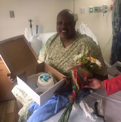 Edward Simmons in hospital bed, with wedding cake and flowers