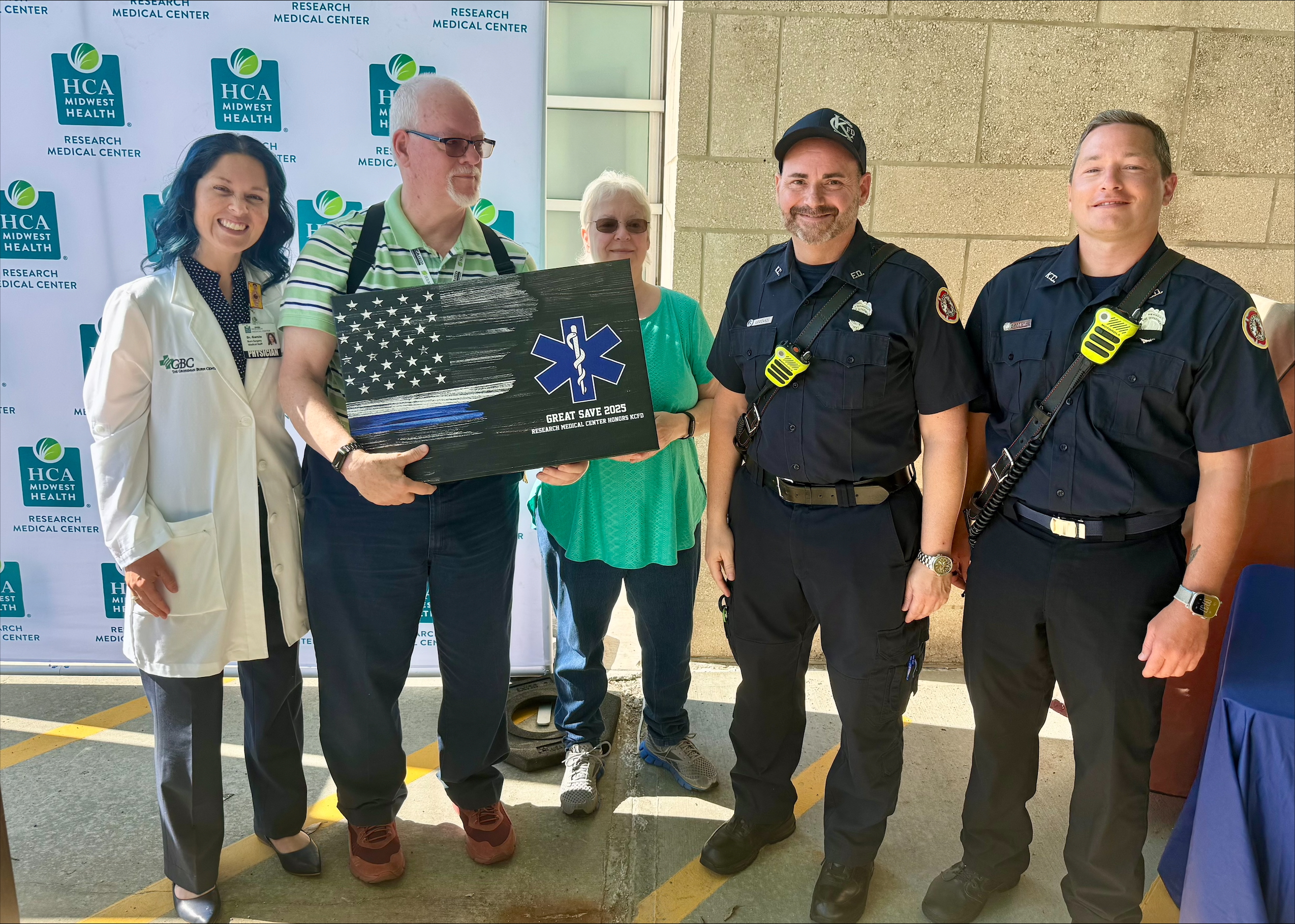 Physicians, care teams, EMS partners, and First Responders with former trauma patient.