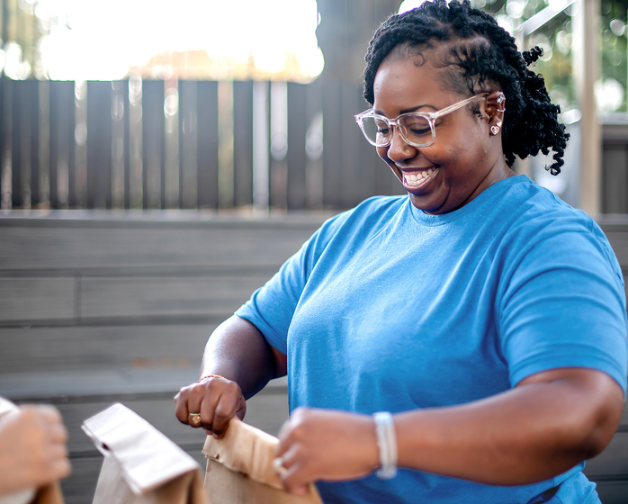 Person putting together bags of food for charity