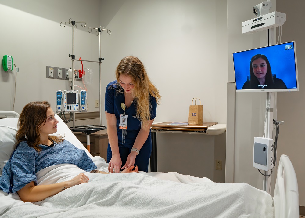 Photo is of Rachel Taylor, registered nurse at TriStar Skyline, participating with a patient and virtual nurse.