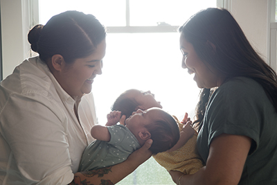Vanessa Rodriguez and Doctor Elizabeth de la Garza holding Vanessa's babies.