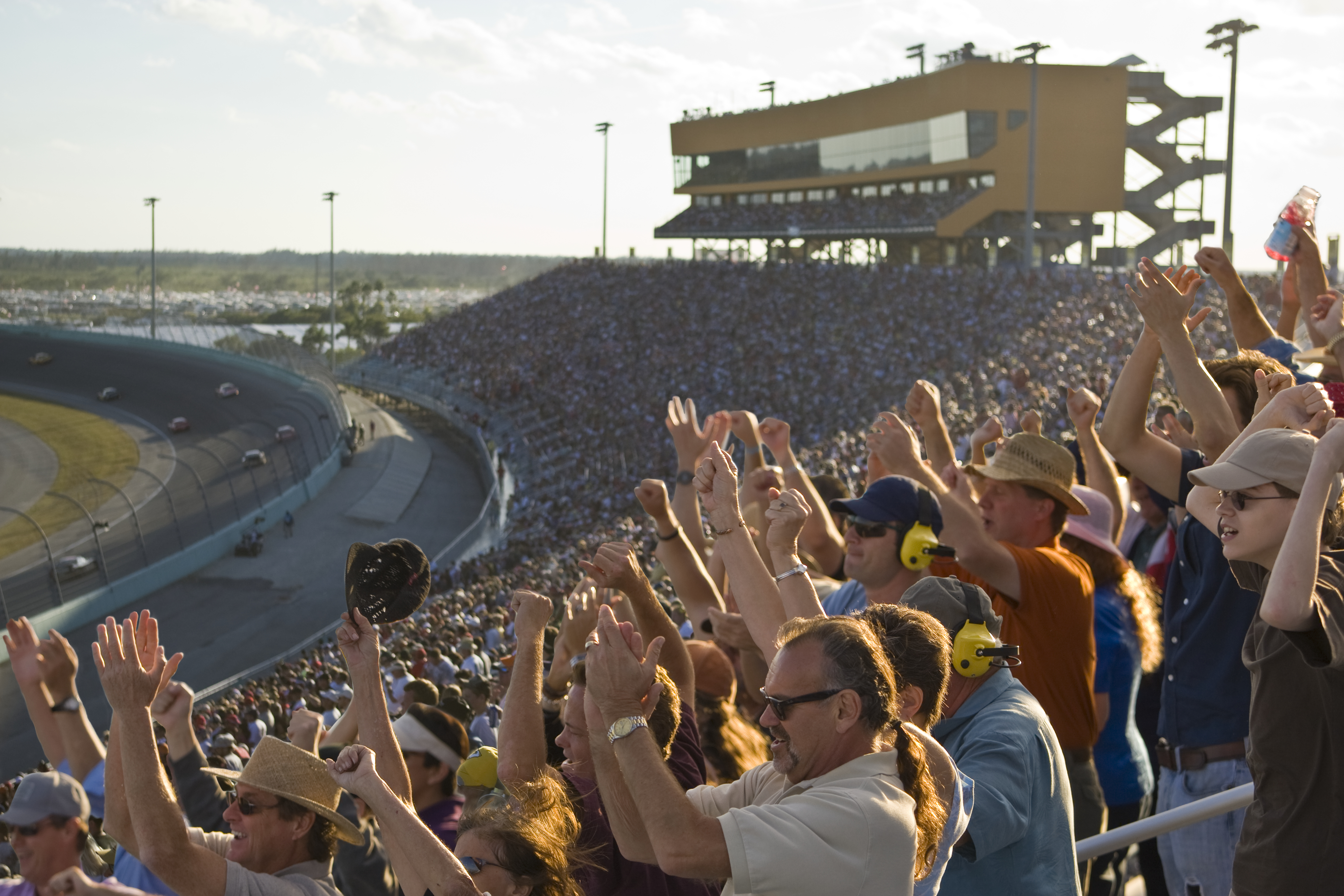 Racing fans cheer as cars circle the track during Daytona 500 race