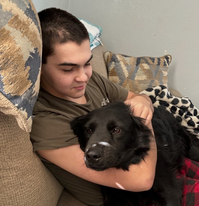 Photo of Ashton Hodge and his dog.