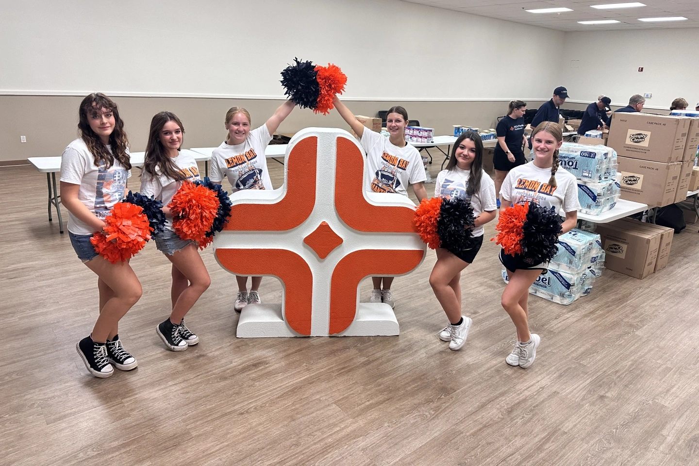 Cheerleaders from Lemon Bay High School passed out emergency supplies and food to employees as they visited the drive through mini-mart.