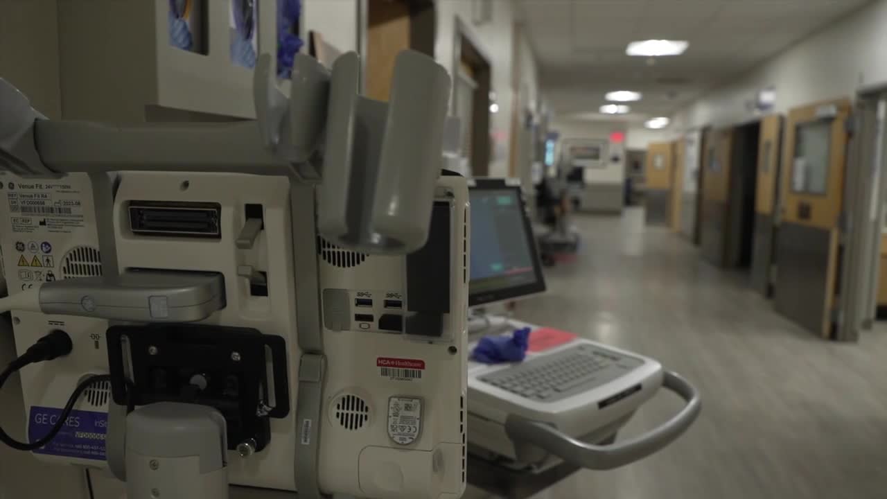 Medical Equipment/Card, hospital Hallway with multiple room entrances on the background.