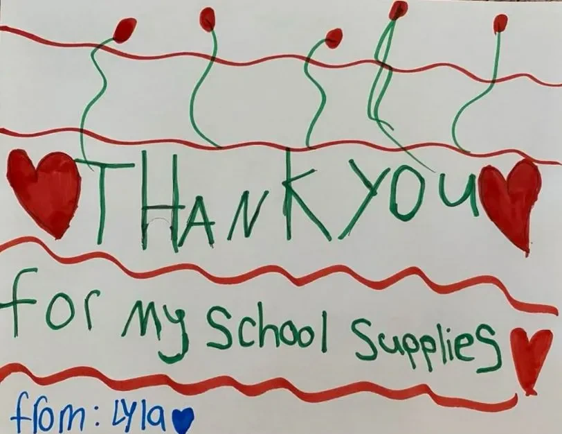 A note that reads Thank you for my school supplies designed by Lyla, student.