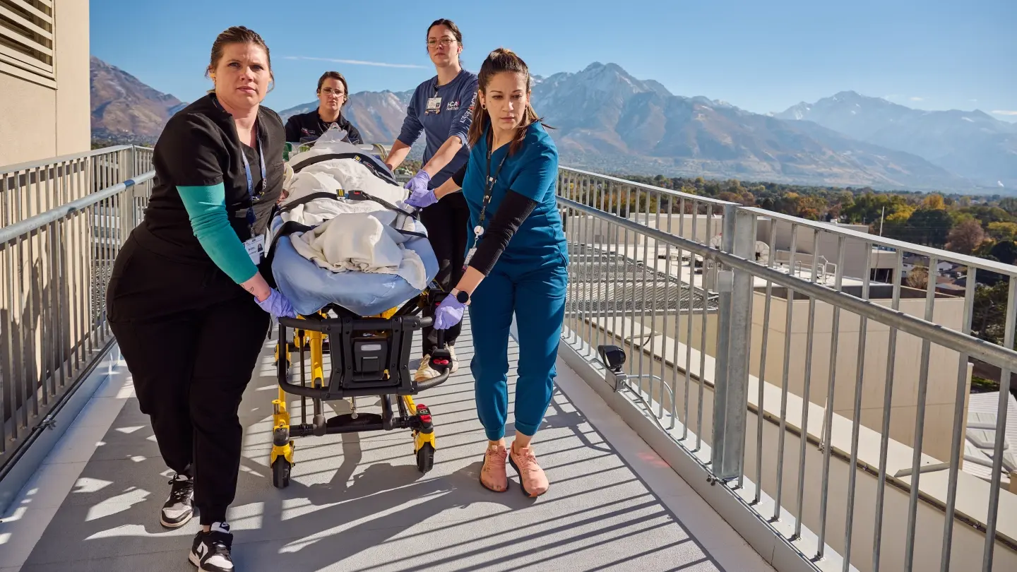 Four caregivers assisting a patient inside