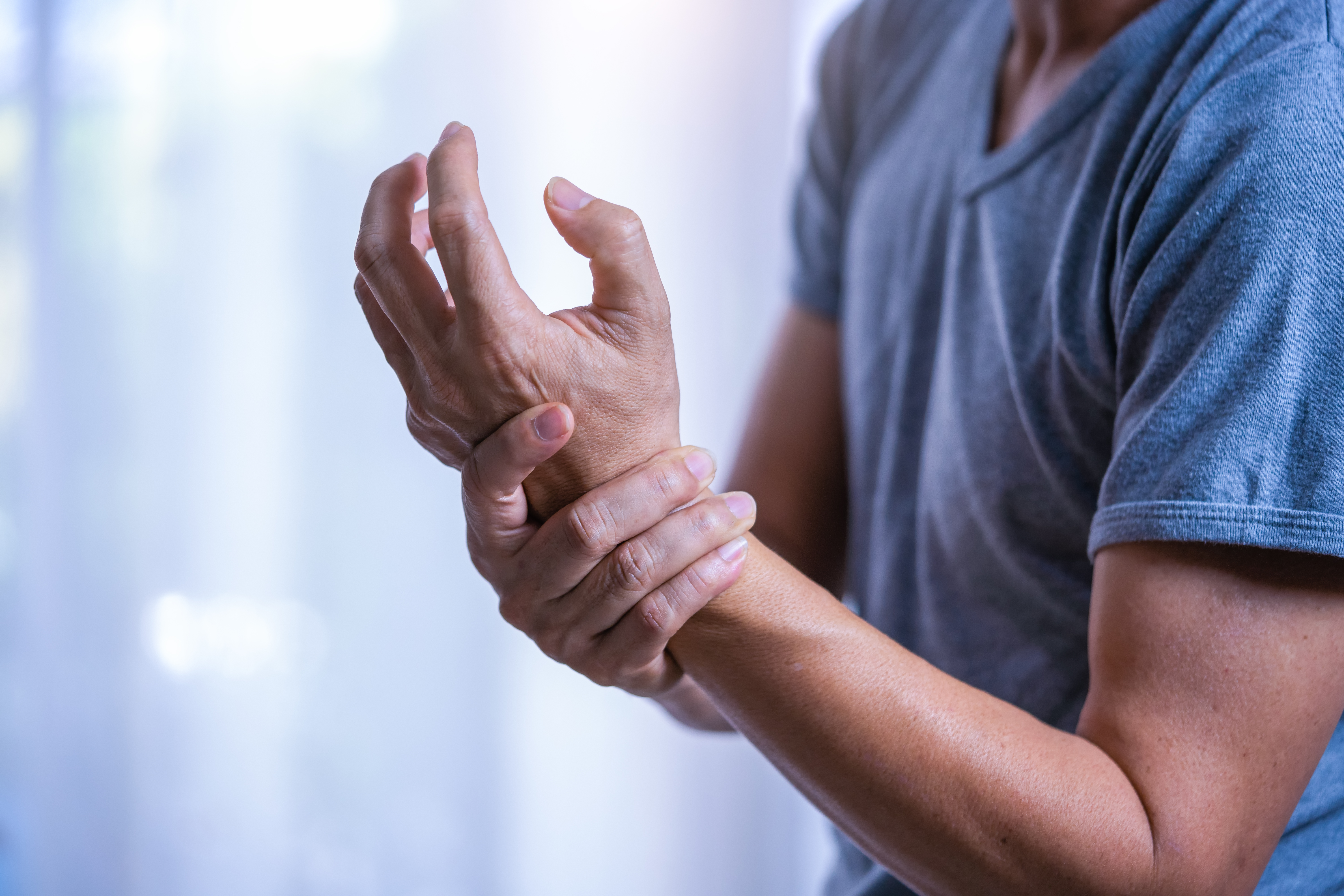 A man holds his wrist in pain