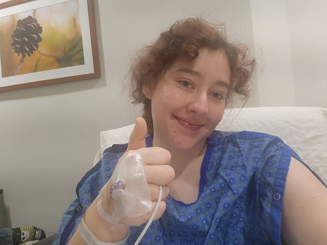 Ivy Sabaini-Kizewski sitting in a hospital bed