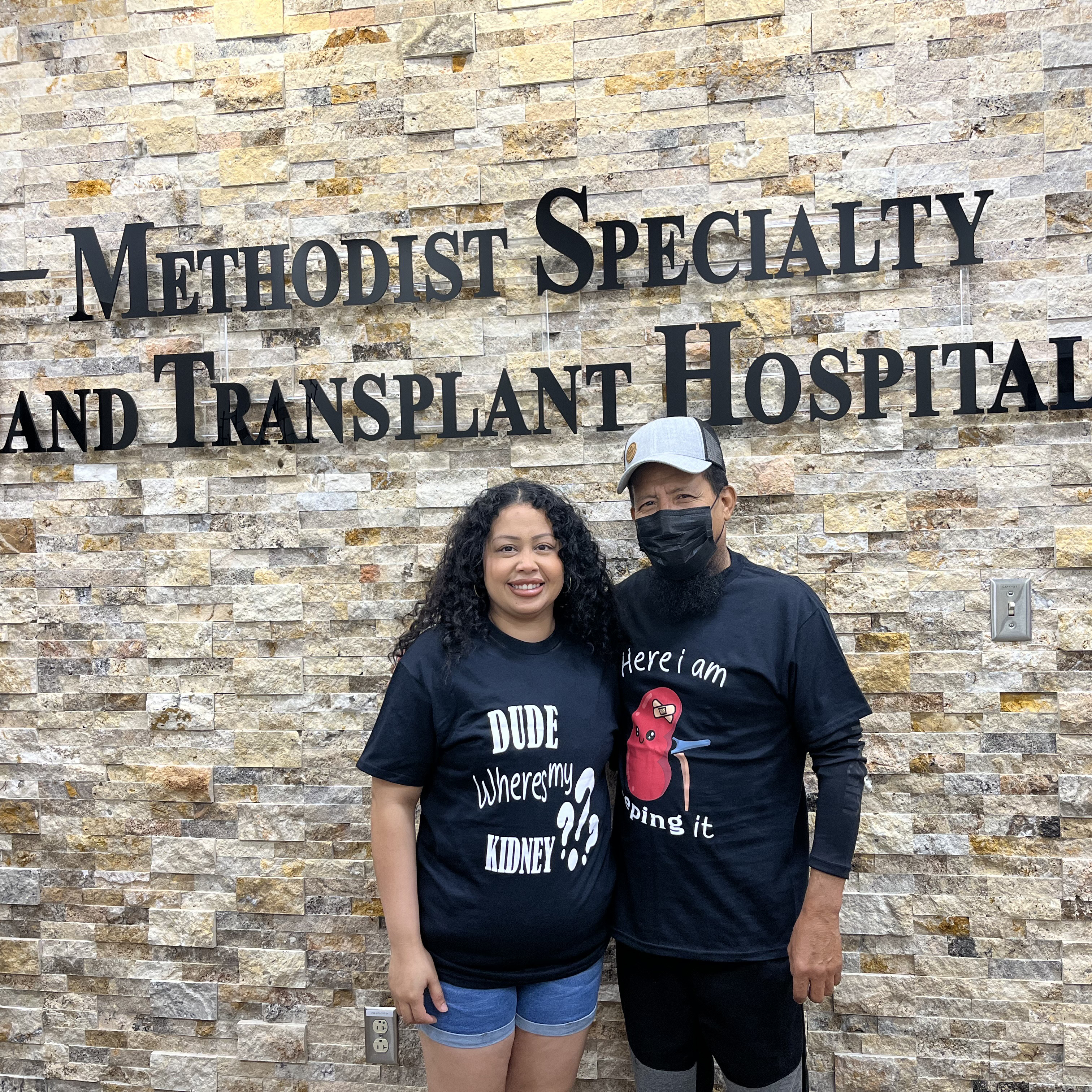 Eloisa and Adan standing in front of the Methodist Hospital Specialty and Transplant sign