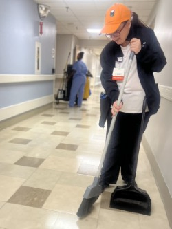 Parc Center for Disabilities programs volunteer sweeping a floor
