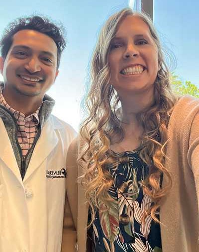 Dr. Nikhil Sahasrabudhe and his former patient Amanda smiling. 