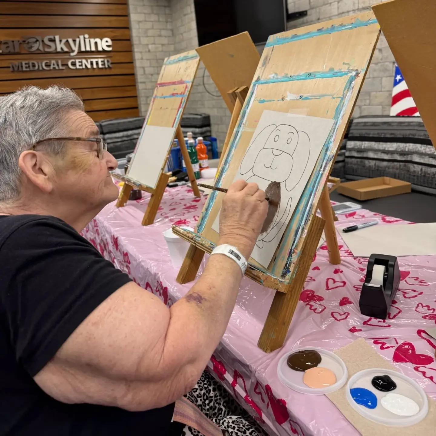 Linda painting a picture during a recent therapy session.