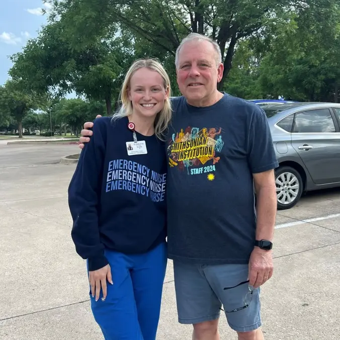 nurse Madie Wood hugged by patient Jeff Belles in parking lot