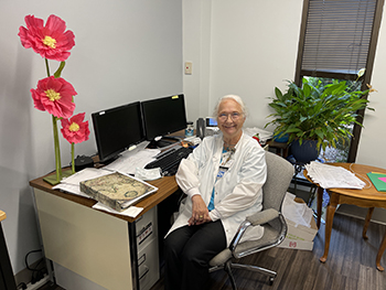 Becky Allgood sitting down at a desk.