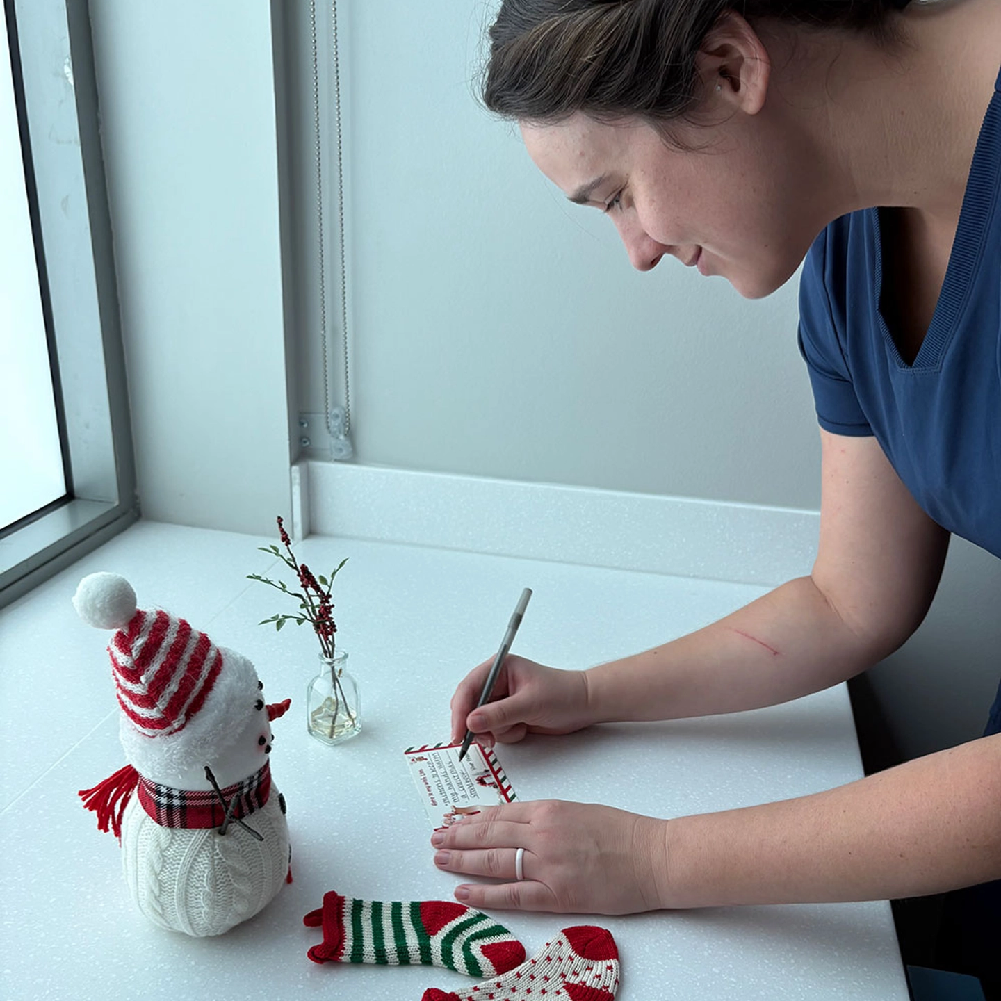 Nurse writing a letter to santa.