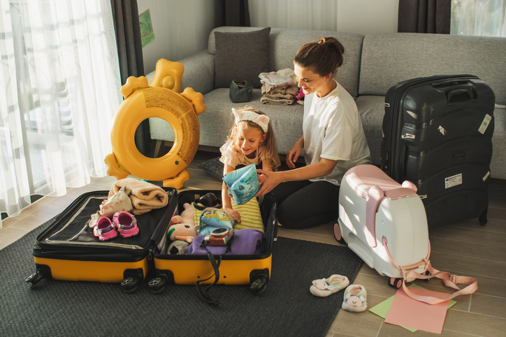 Mother and daughter packing for summer vacation.