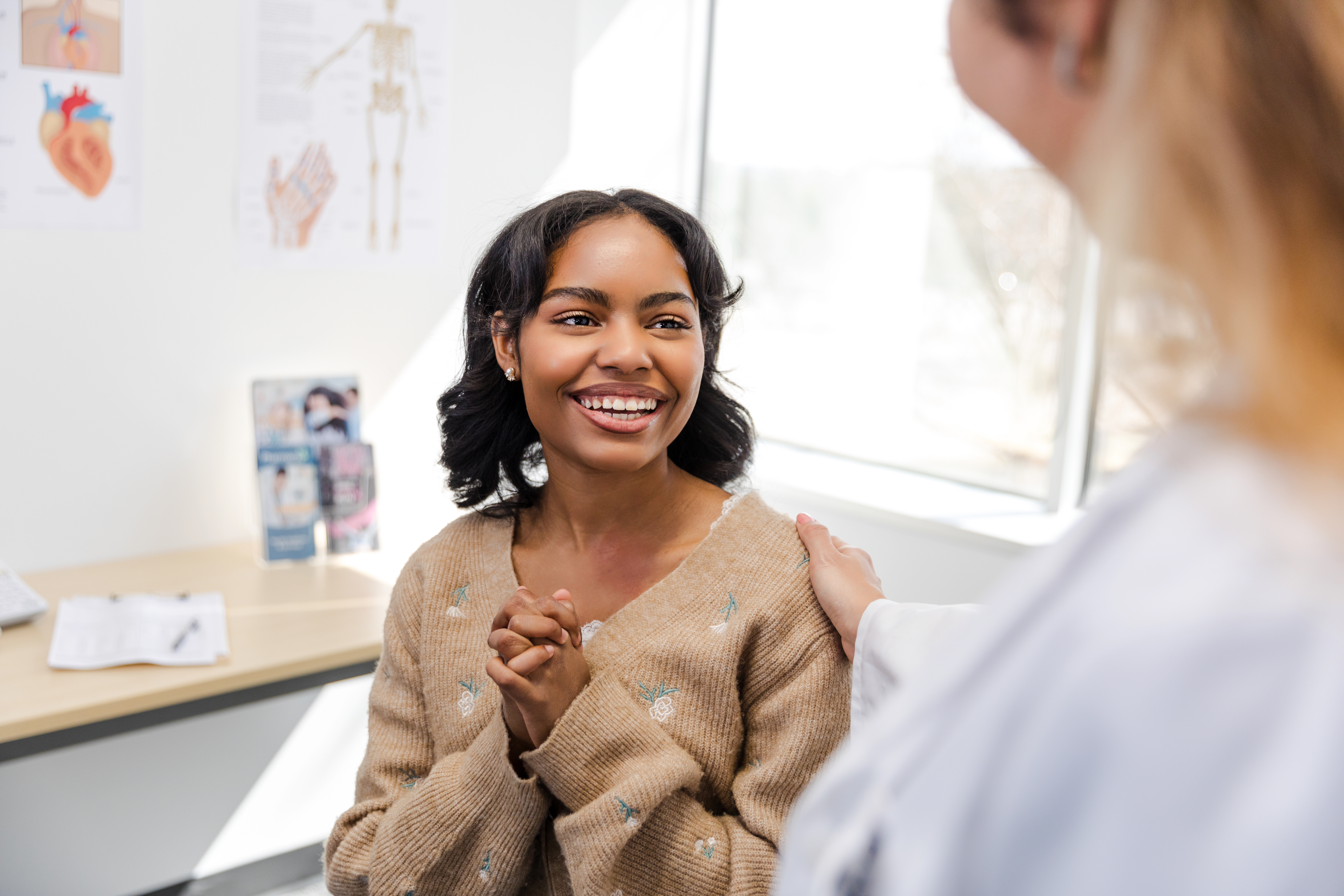 Happy female patient smiling at doctor.