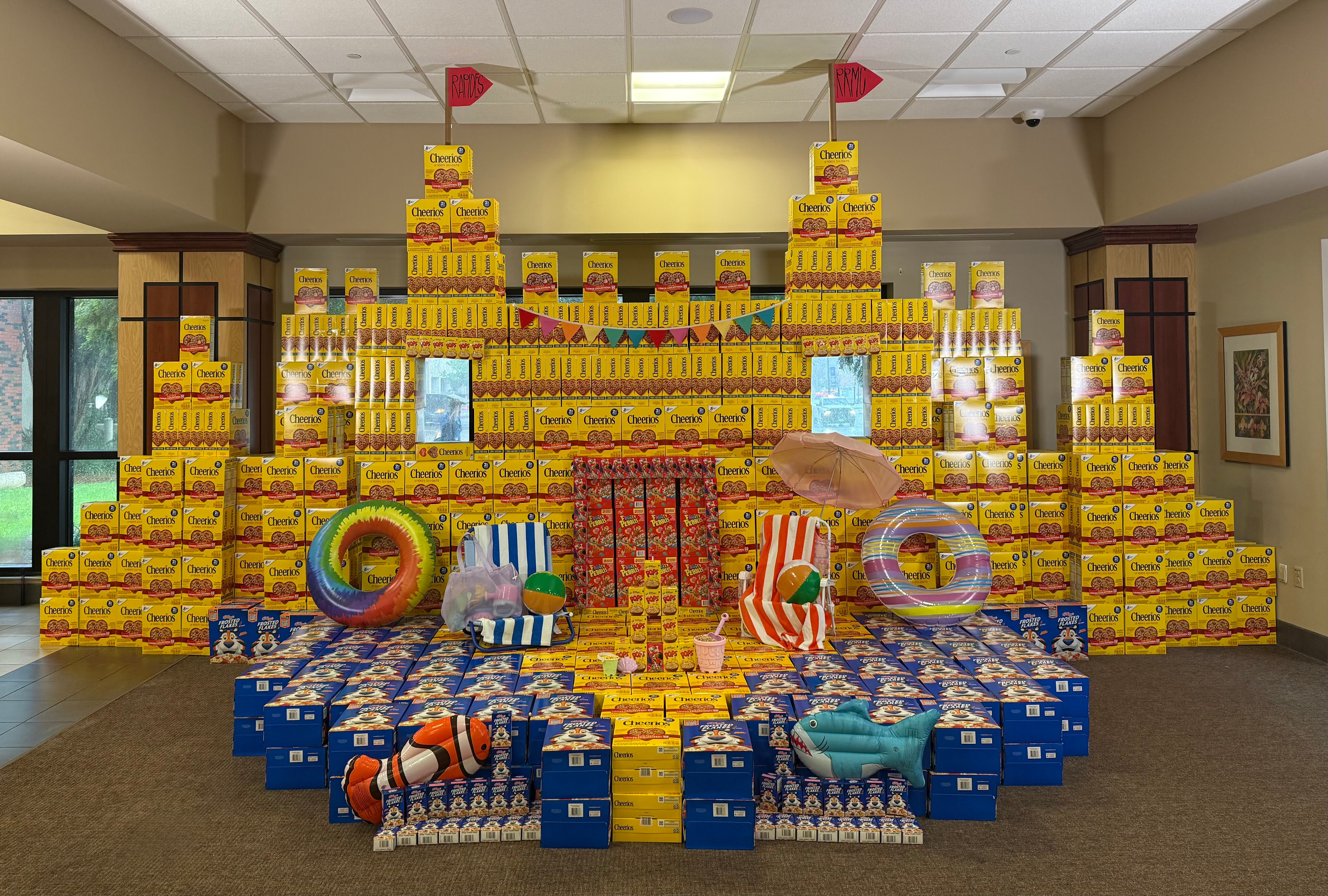 Food boxes and cans stacked into shape of a large sand castle