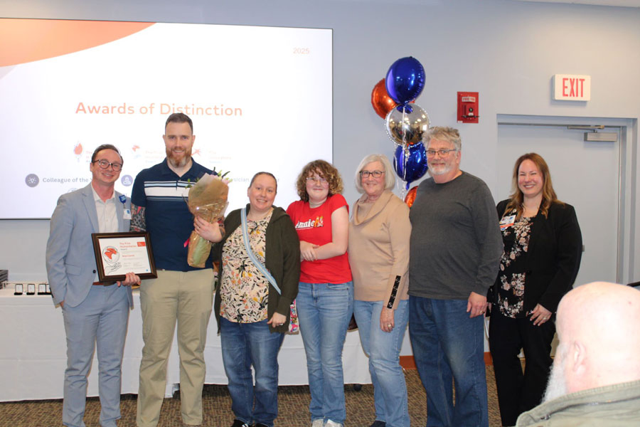 Brian Carroll, RRT, posing with family and colleagues after receiving the Frist Humanitarian - Employee Award.